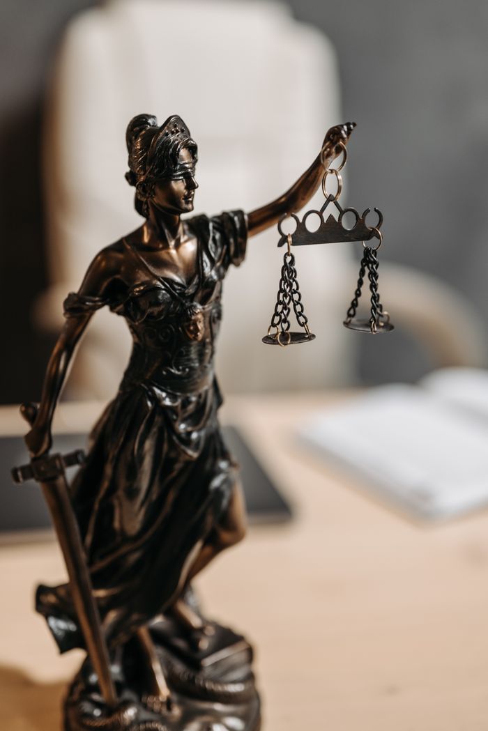 The Art of Drawing Readers In: Your attractive post title goes here Bronze Lady Justice statue with scales and sword, symbolizing fairness and law.